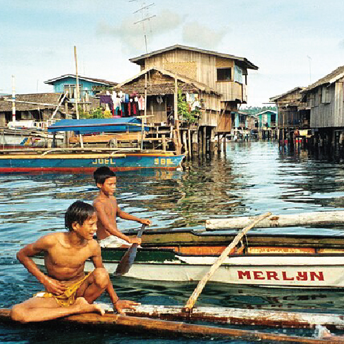 A group of boys rowing a boat in the water

Description automatically generated