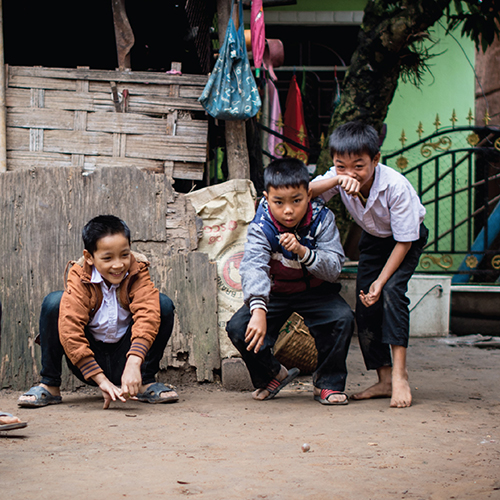 A group of boys playing with a ball

Description automatically generated