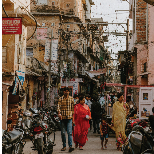 A group of people walking down a street

Description automatically generated