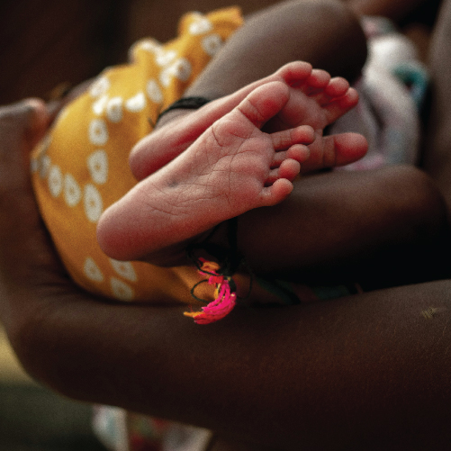 Close-up of a baby's feet in a person's hands

Description automatically generated